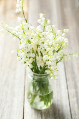 Lily of the Valley on grey wooden background