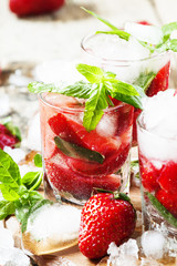 Strawberry cocktail with mint and ice, selective focus