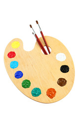 Wooden art palette with paints isolated on white