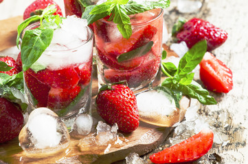 Strawberry cocktail with mint and ice, selective focus