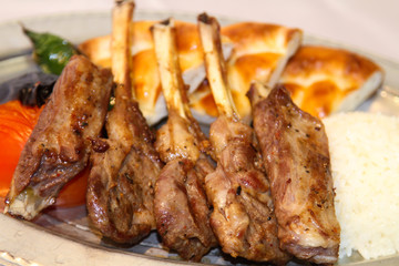 Delilcious lamp chops served in a white plate.