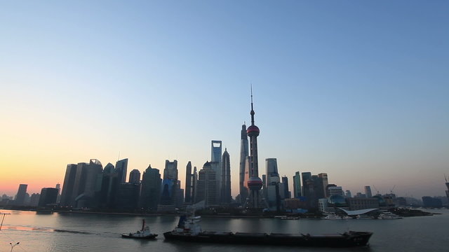 shanghai skyline with a large cargo ship  in sunrise 