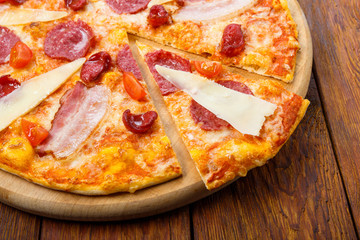 Delicious italian pizza with salami, bacon and parmesan