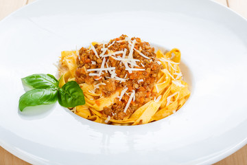 Traditional italian bolognese pasta at white plate