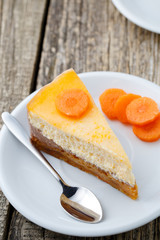 Sweet slice of carrot cake on white plate.