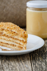 Tasty honey cake with jar of honey.