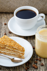 Tasty honey cake with jar of honey.