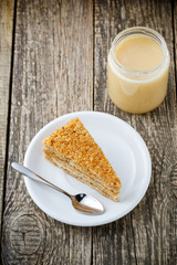 Tasty honey cake with jar of honey.