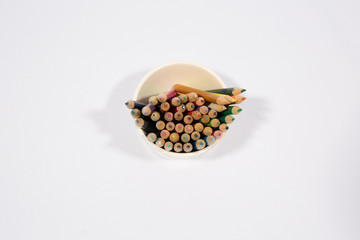 Colorful pencils in pail isolated on white background