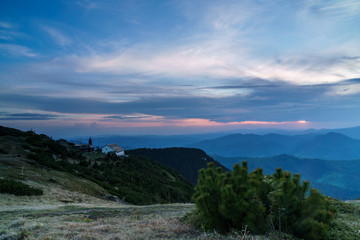 Fototapeta na wymiar church in the mountains at sunset