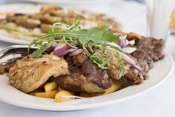 Mixed grilled meat served on restaurant table