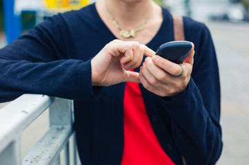 Woman using smart phone outside
