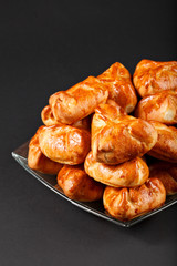 Hot tasty small russian pie on the plate