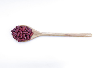 Red beans on wooden spoon isolated on white