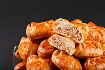 hot tasty traditional russian baking small pie with fish from ow