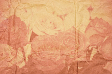 Textured old paper with vintage roses in double exposure