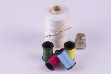 Colored thread with a needle and thimble