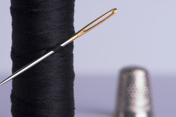 Thread with a needle and thimble