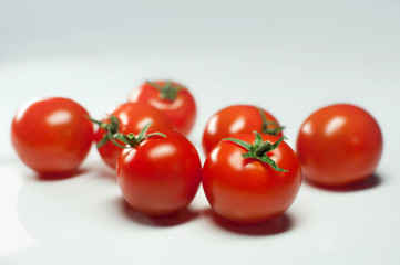 Cherry tomatoes on a light background close up
