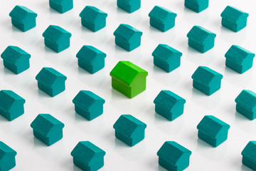 Large green house in group of smaller green turquoise houses.