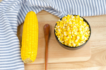 Sweet corn in bowl on wooden table