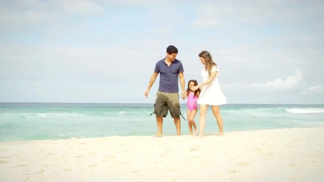 Daughter walks down a beach with her parents in Brazil