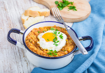 Fried egg with cooked lentils