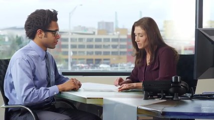 Successful Business professionals review and sign a deal