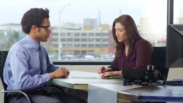 Successful Business professionals review and sign a deal