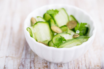 Salad with fresh cucumber, pumpkin seeds and fresh parsley