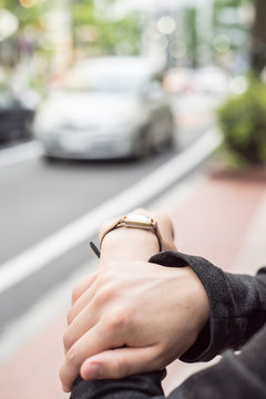 街中で腕時計を確認する女性の手