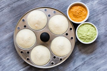 Indian breakfast food idli served with chutneys