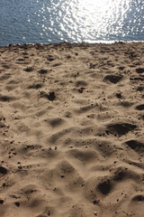 Sand beach and sparkling river water