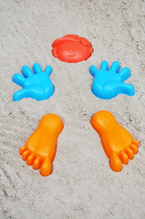 Fototapeta na wymiar Formen Kopf, Hand, und Fuß in einem Sandkasten