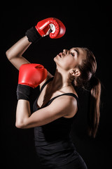 Beautiful young woman in a red boxing gloves