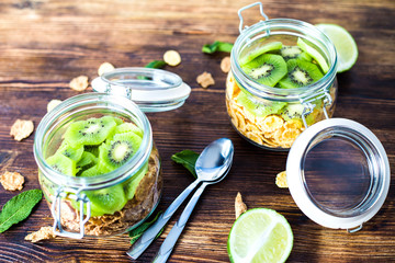 Wheat and corn flakes with yogurt and kiwi in the jar