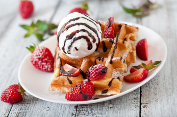 Fototapeta na wymiar Belgium waffles with strawberries and ice cream 