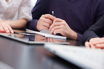 hand a group of businessmen on a table with a tablet, mobile pho