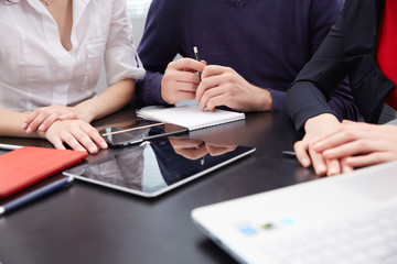 hand a group of businessmen on a table with a tablet, mobile pho