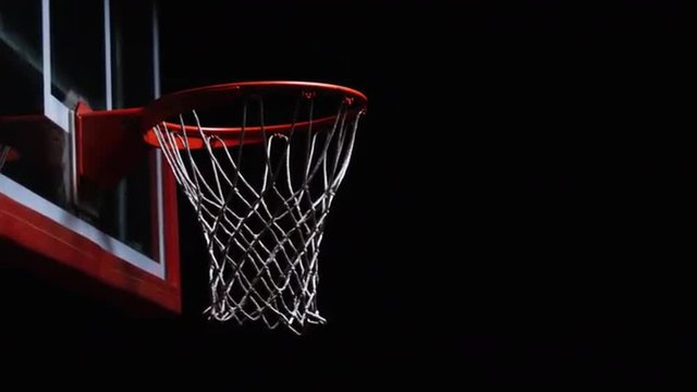 Close up of a basketball dunk.
