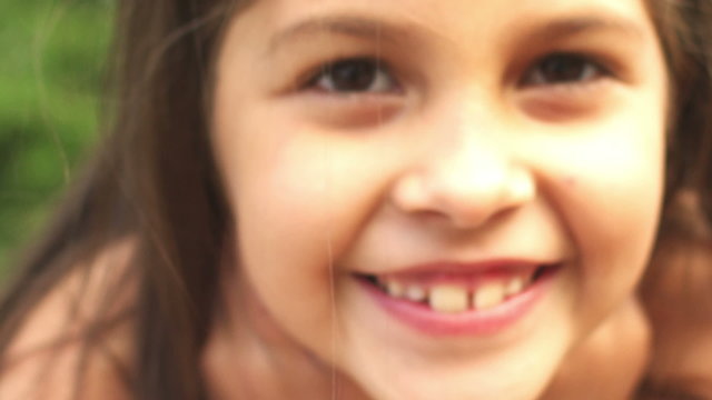 Adorable little girl smiles for the camera. 