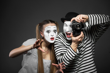 Funny couple of mimes taking a photo