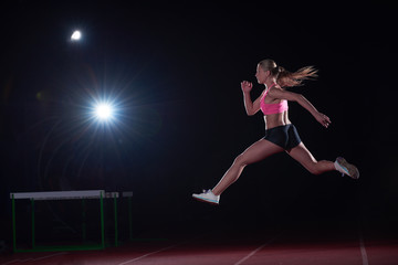 Athletic woman running on track