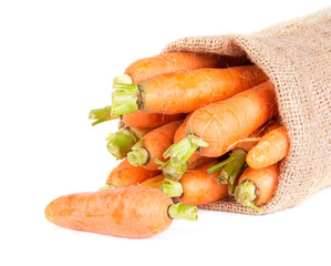 carrots in a burlap bag isolated on white background