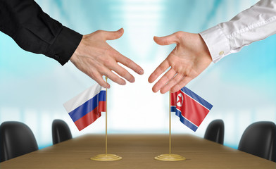 Russia and North Korea diplomats agreeing on a deal