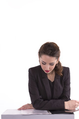  businesswoman reading documents at desk