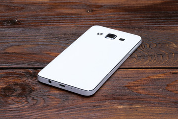 Smart phone lying on wooden table