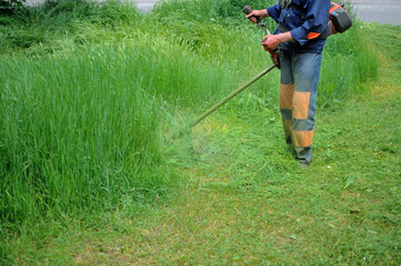 Man mows grass