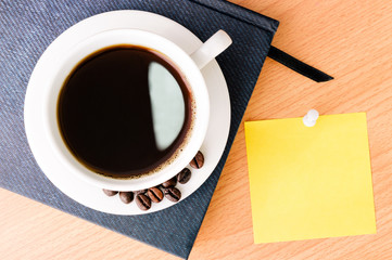 coffee and note pad on wood desk table