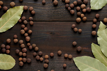 bay leaf and allspice on a wooden table